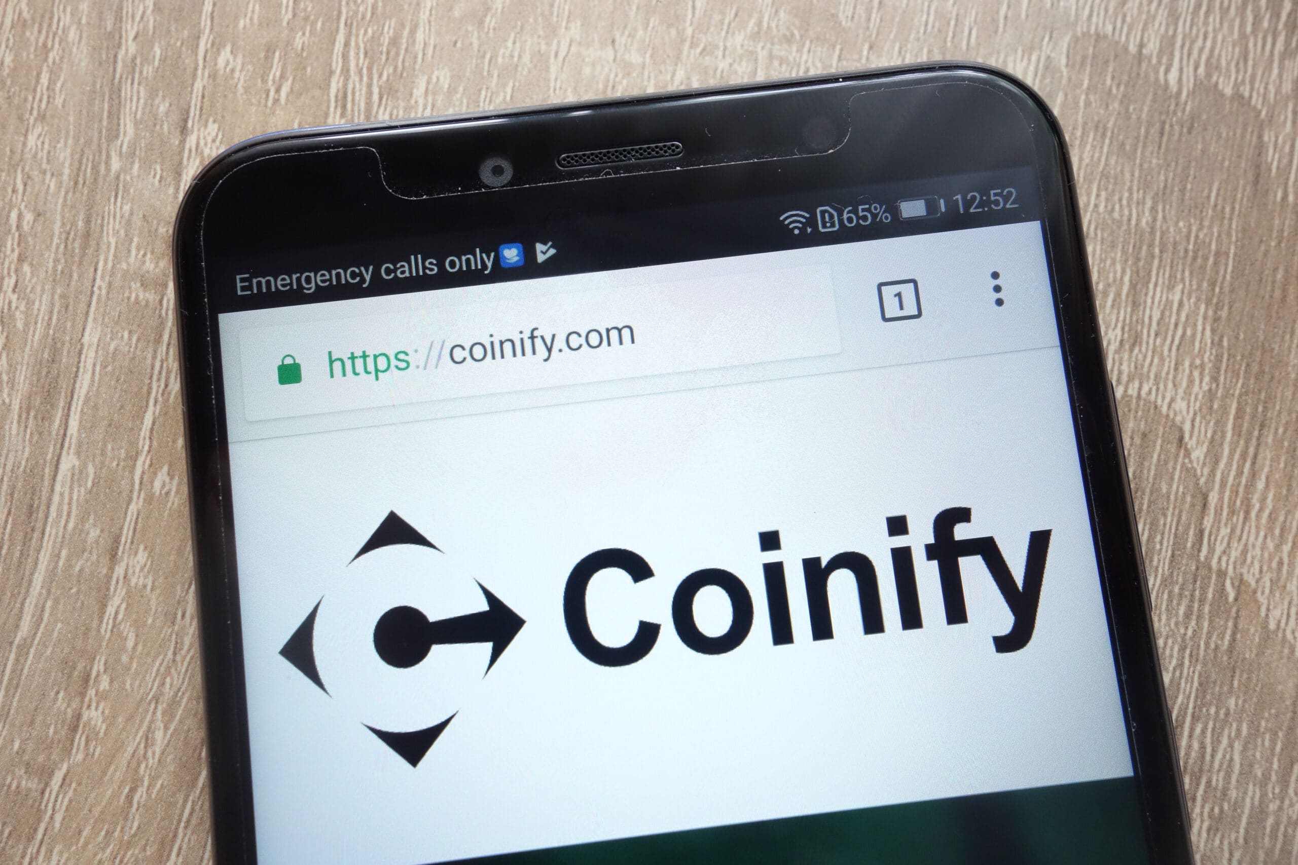 Coinify logo on a phone.